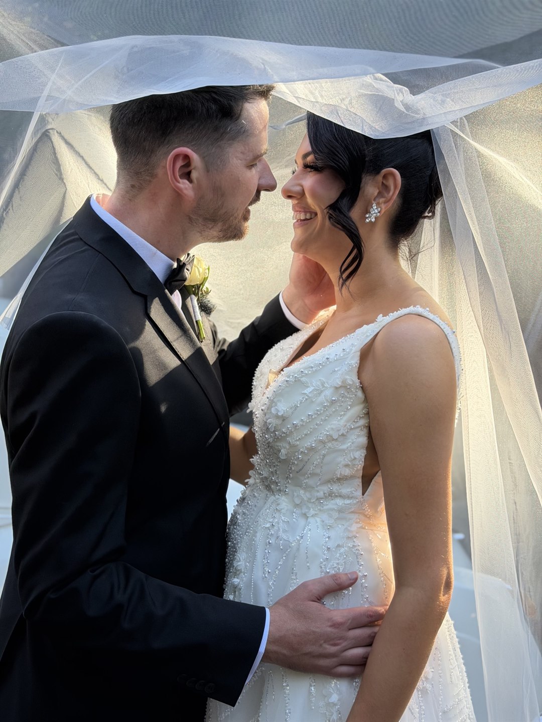 Maddison and Beau beneath the veil on their wedding day